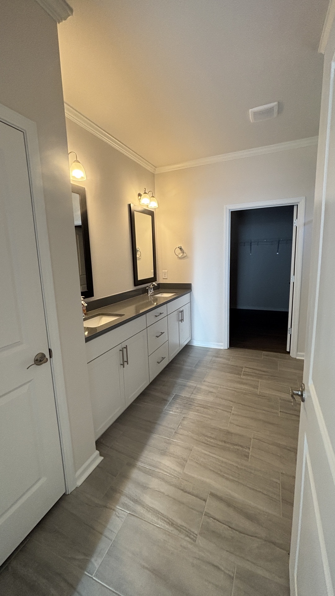 Master bath remodel, Mebane NC. Double vanity, white shaker cabinets, porcelain tile floor, crown molding.