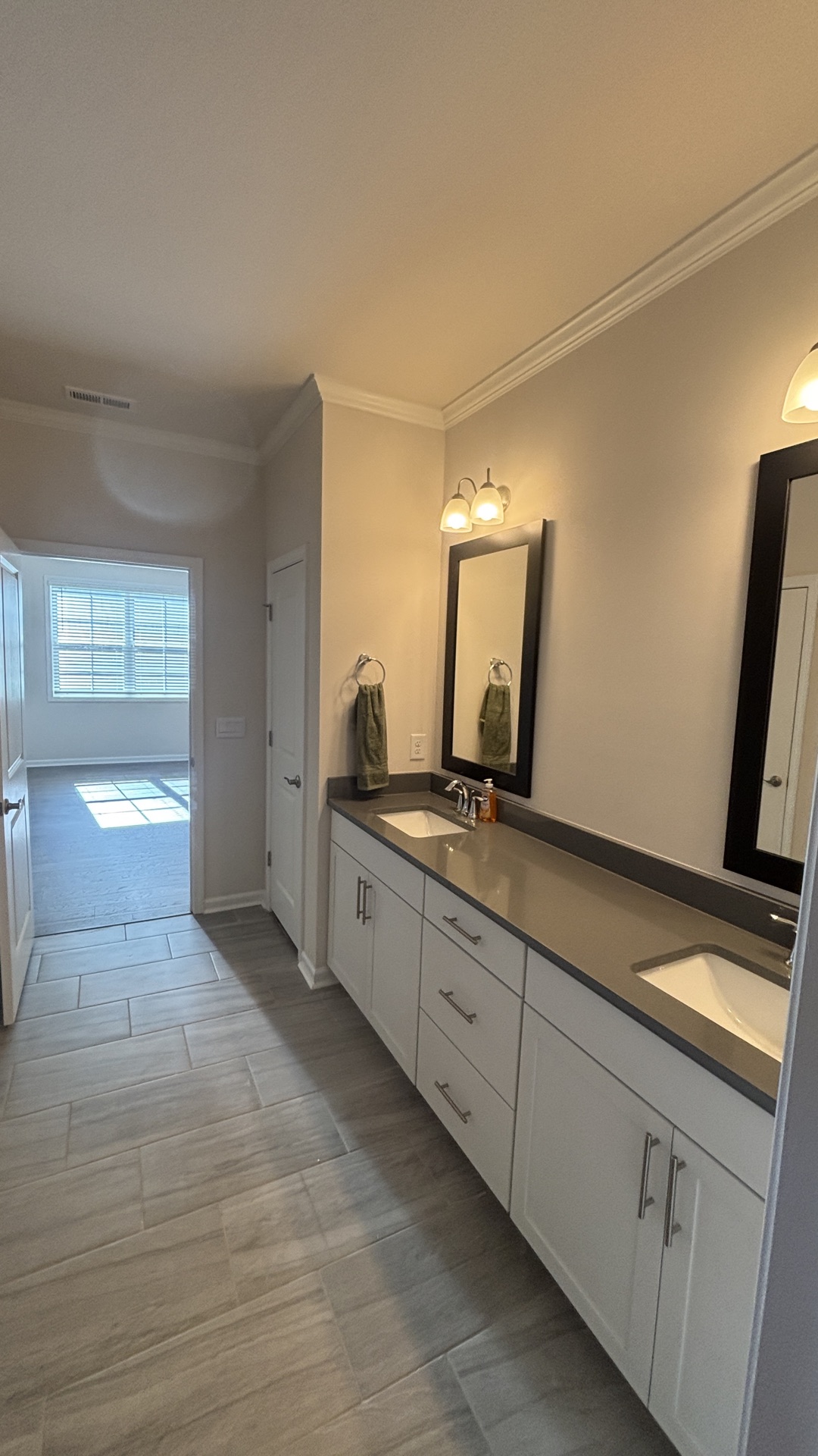 Bathroom vanity installation, Mebane NC. Double vanity, white shaker cabinets, gray quartz.
